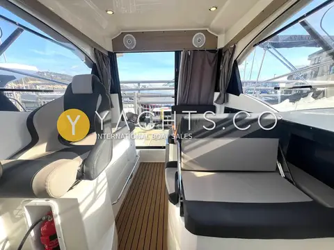 Parker 750 CC: wheelhouse looking aft to the patio door, with grey seating and teak-effect sole