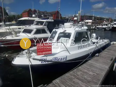 Pirate 21: port side view afloat with For Sale board on the rail and name on the bow