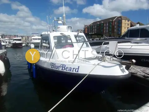 Pirate 21: bow view afloat showing white hull, dark topsides, blue fenders and cuddy roof radar