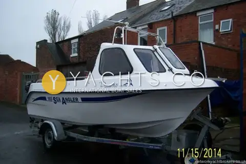 Predator 165: starboard side on trailer, white hull with Sea Angler graphics, cuddy and stainless arch