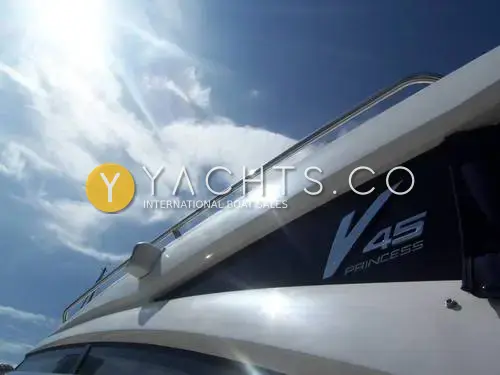 Princess V45: close view of the V45 Princess hull graphic and stainless grab rail against a bright sky