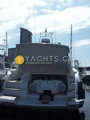 Princess V45: stern with the transom garage open showing the tender storage area, marina flats behind