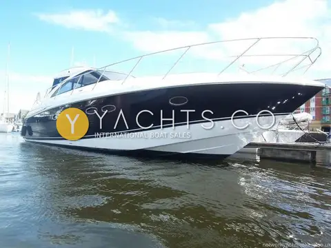 Princess V45: dark blue hull with white boot top and stainless bow rail, moored in Swansea marina