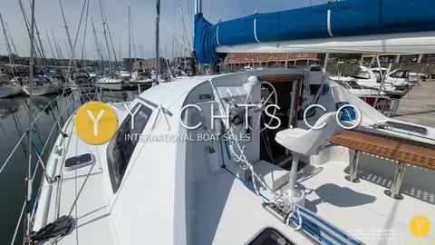 Privilege 37 Catamaran: starboard side deck leading aft to the external helm with wheel and white seat