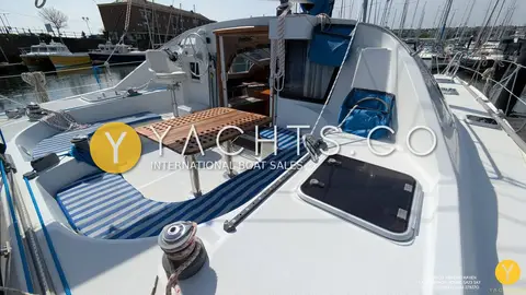 Privilege 37 Catamaran: aft cockpit with blue striped cushions around a teak folding table