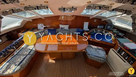 Privilege 37 Catamaran: saloon with large varnished oval table, wraparound windows and chart table
