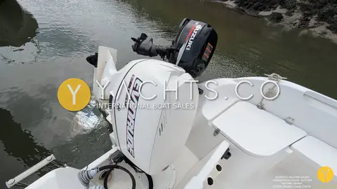 Quicksilver 500 Pilothouse: evinrude outboard on the transom with smaller auxiliary outboard on its bracket alongside