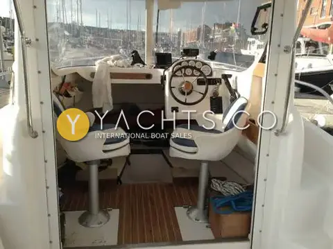 Quicksilver 630 SD *diesel*: wheelhouse interior seen from aft with two pedestal helm seats and teak-effect sole