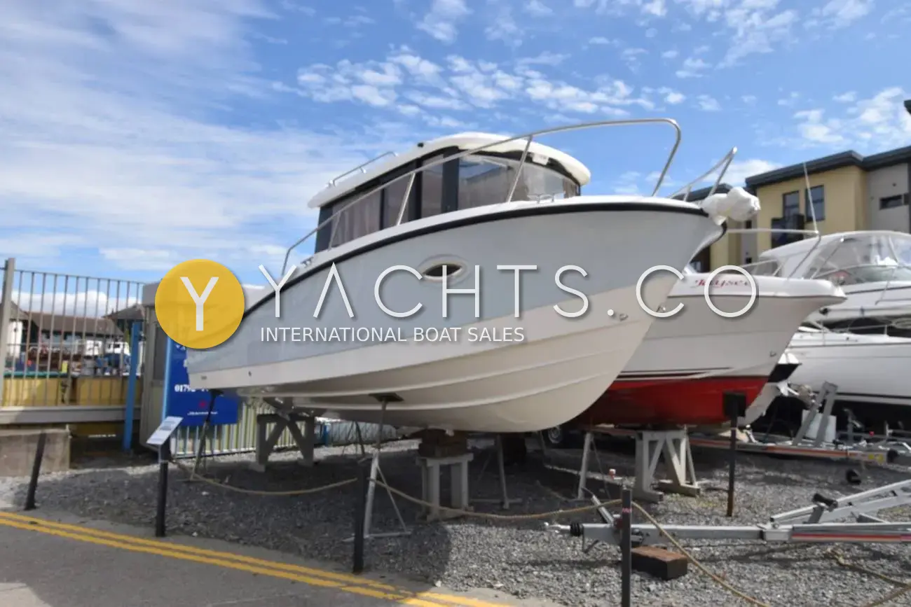 Quicksilver 755 Pilothouse: port bow view of the pale grey coloured hull ashore on stands in a Swansea boatyard
