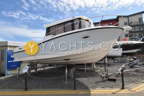 Quicksilver 755 Pilothouse: port side profile on stands showing grey hull, pilothouse with curtains and bow rail