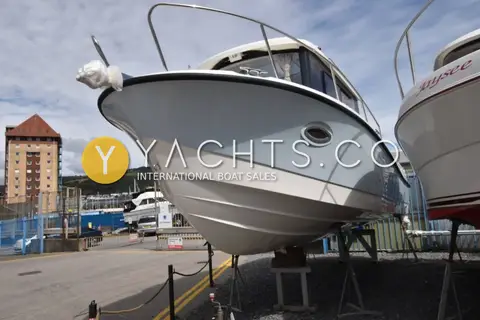 Quicksilver 755 Pilothouse: low view of the bow and starboard hull with portlight, ashore beside other boats