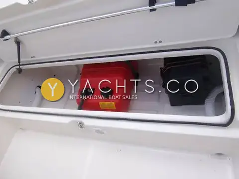 Quicksilver Activ 455: open aft locker holding a red portable fuel tank and black battery box