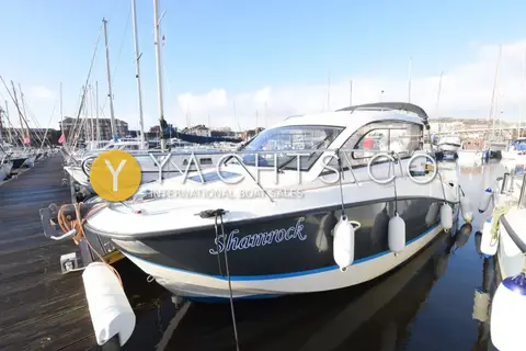 Quicksilver Activ 705: dark blue hull with white topsides, moored on a marina pontoon with fenders out