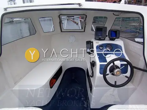 Raider 18: wheelhouse interior showing U-shaped seating, forward hatch and helm console with electronics