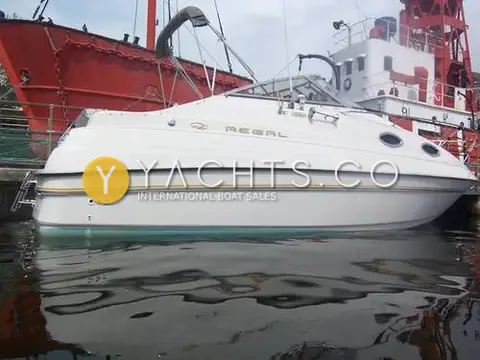 Regal 242 Commodore: port side hull with gold stripe, moored beside a red lightship