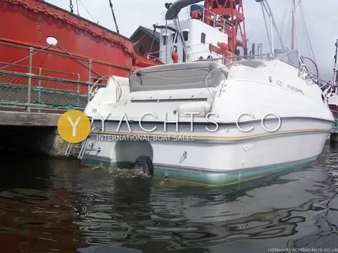 Regal 242 Commodore: stern quarter showing extended swim platform, stainless ladder and sterndrive leg
