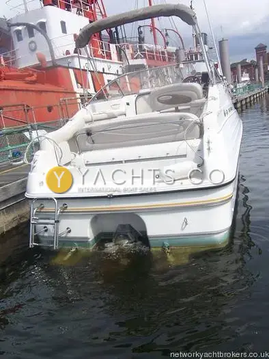 Regal 242 Commodore: stern view with swim ladder, cockpit seating and folded canopy frame above