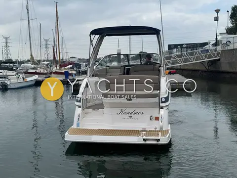 Regal 28 Express: stern view showing teak-effect bathing platform, transom name and cockpit under the bimini