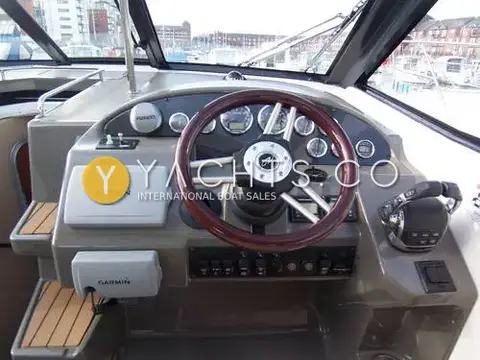 Regal 35 Sports Cruiser: helm with wooden steering wheel, two Garmin units, gauges and single lever controls