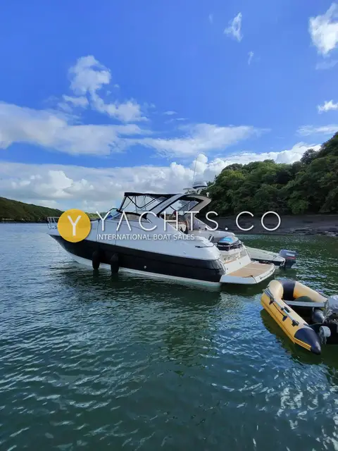 Regal 3760: at anchor in a wooded river with a yellow inflatable tender alongside