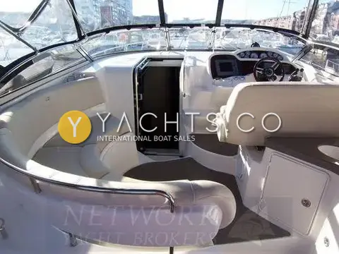 Regal 3760: cockpit with curved cream seating, open companionway door and helm under the canopy