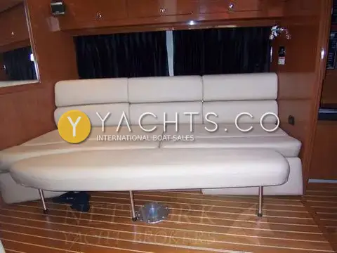 Regal 3760: cream leatherette settee with filler cushion below black curtains and gloss wood lockers