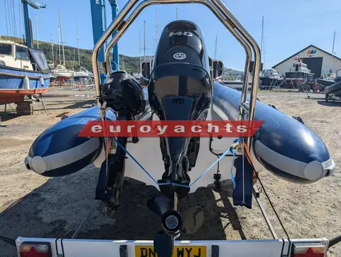 Ribcraft 585: stern view of the outboard under the stainless A-frame, with the auxiliary engine alongside