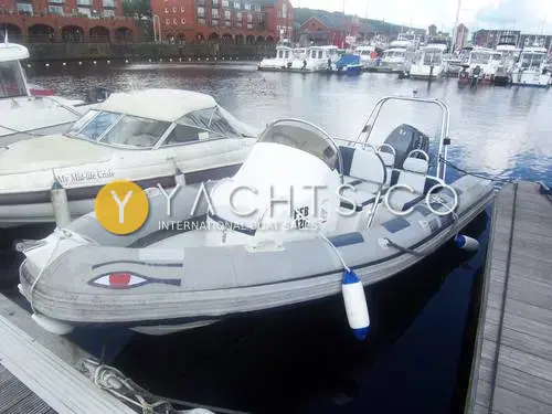 Ribeye 550 Playtime: grey RIB with blue and grey tubes and painted eye on the bow, berthed in a marina