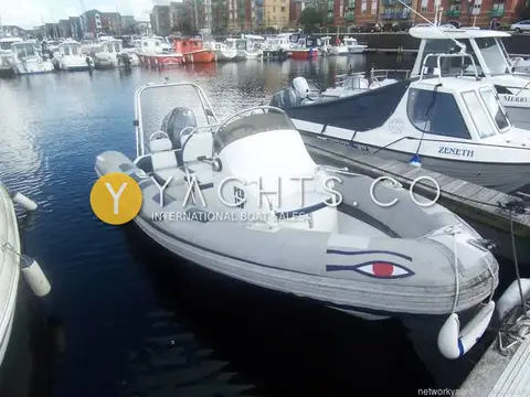 Ribeye 550 Playtime: port side view of the RIB alongside a pontoon, showing tubes, console and tower