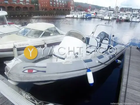 Ribeye 550 Playtime: bow quarter view in the marina with painted eye on the tubes and console amidships