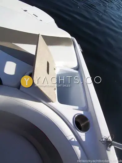 Rinker 192 Reduced: side deck storage recess with a raised lid and stainless cup holder