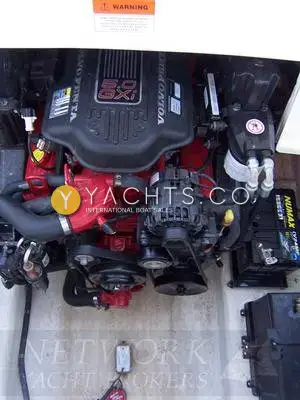 Rinker 230: engine bay showing red Volvo 5.0 GXi petrol engine with black cover and battery