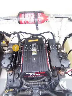 Rinker 232: engine bay showing the 350 Mag MPI V8 with fire extinguisher mounted above