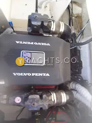 Rinker 232: engine bay showing black Volvo Penta 5.0 GXi engine cover and exhaust fittings