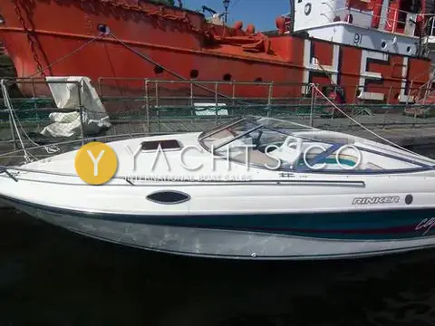 Rinker 232: port side of the white hull moored beside a red lightship
