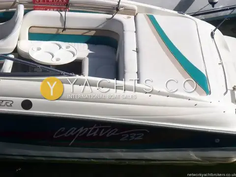 Rinker 232: stern sun pad and U-shaped rear seating with round cockpit table