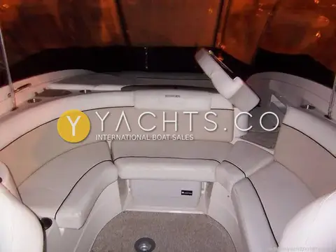 Rinker 246: u-shaped aft cockpit lounge photographed at night under the closed canopy