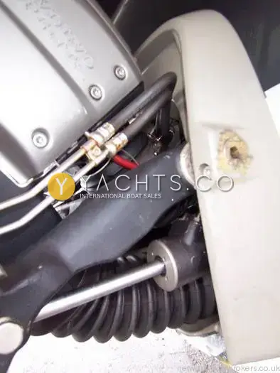 Rinker 262: close-up of stern drive steering rams, hoses and bellows beneath the transom