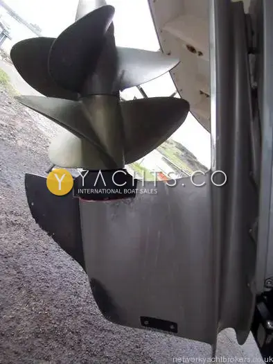 Rinker 262: side view of the drive leg lower unit and twin propellers ashore