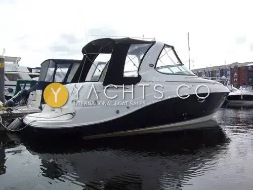 Rinker 280: starboard side view of black-hulled sports cruiser with dark canopy, moored in Swansea marina