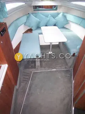 Rio 28: saloon with U-shaped blue upholstered settee, white table and grey carpet