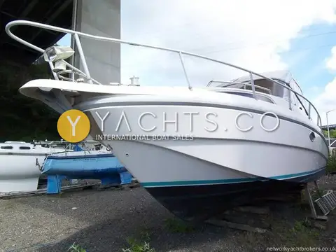 Rio 28: starboard bow ashore under a road bridge, with searchlight and long bow rail