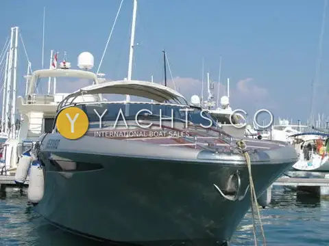 Riva Rivarama 44: bow view of grey hull and mahogany-laid foredeck, moored stern-to among larger yachts