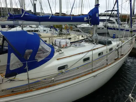 Rival 36: starboard side deck with teak toerail, blue sprayhood and stowed liferaft