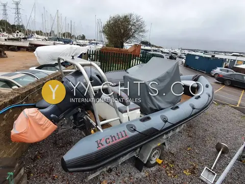 Robust Alimal 570C: stern quarter on trailer showing outboard, A-frame and covered console in boatyard
