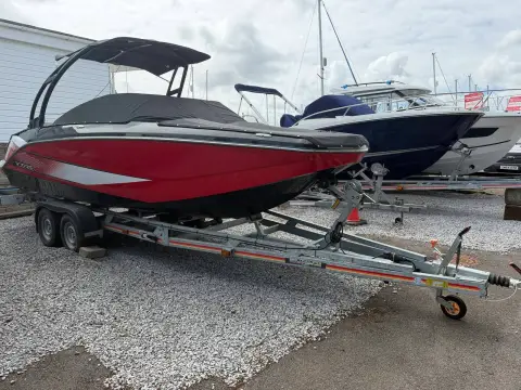 Scarab 215: bow quarter view on the twin axle trailer showing the black tower and red hull