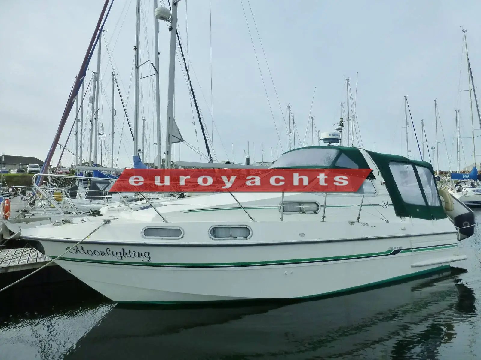 Sealine International 285: white hull afloat in a marina with radar arch, moored among sailing yachts