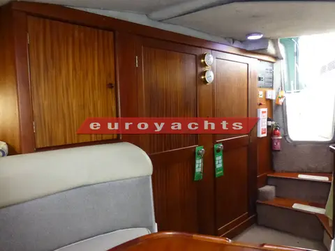 Sealine International 285: wooden joinery and doors to starboard in the saloon, companionway steps to the right