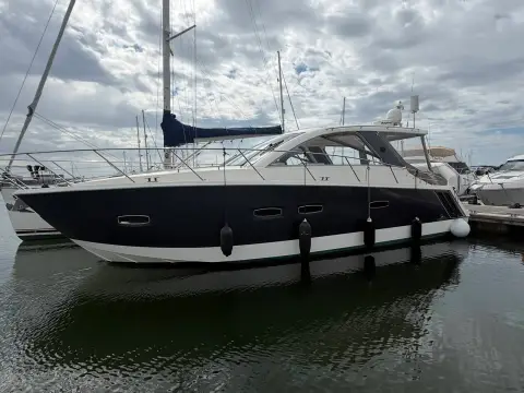 Sealine International SC35: port side of the hull with grey wrap and long hull windows at her berth