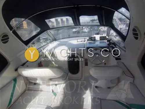 Sealine International Sealine 270 Reduced: cockpit under navy canopy, looking forward to helm seat, companion seat and cabin entrance